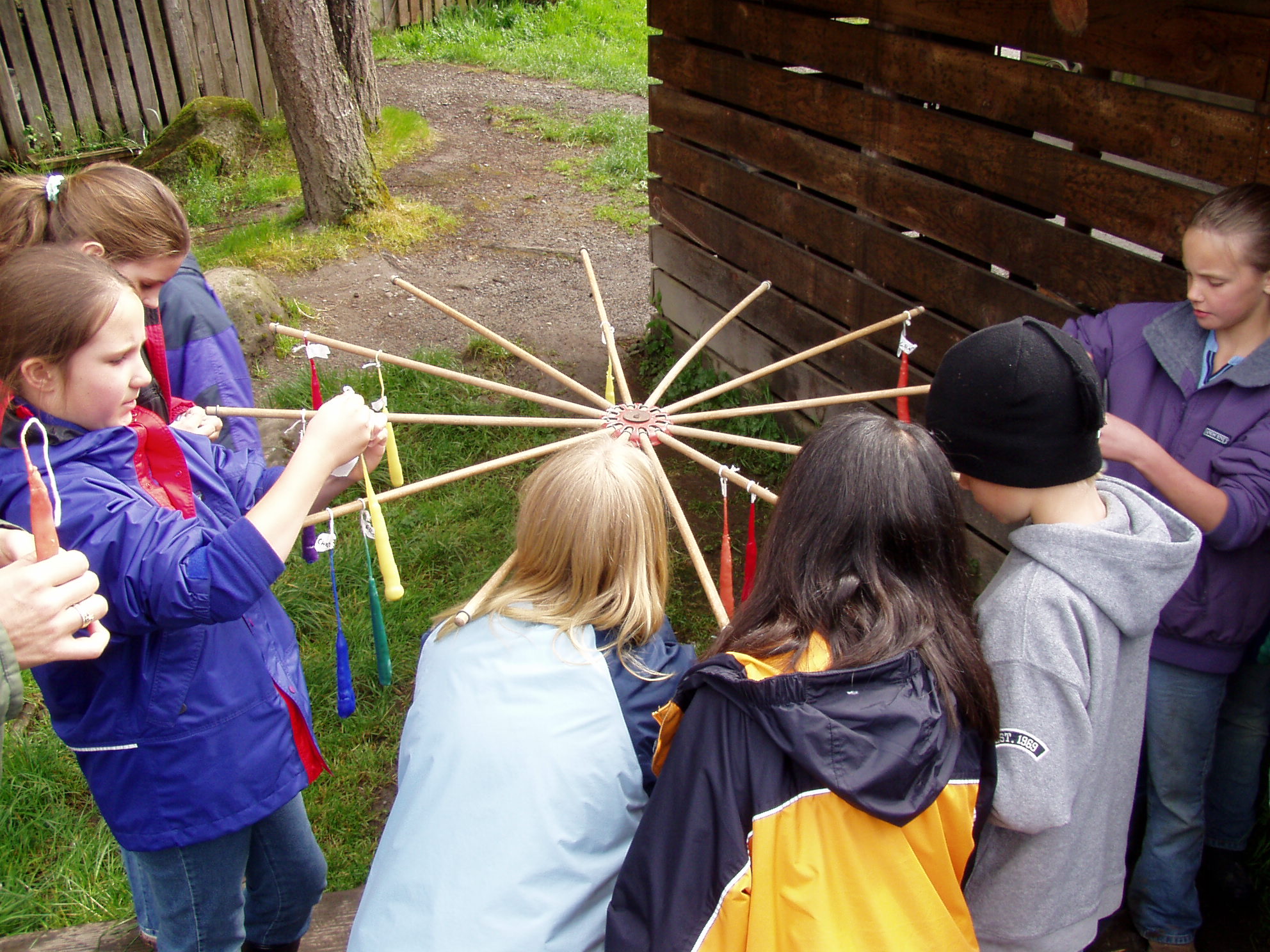 students hanging dipped candles to dry