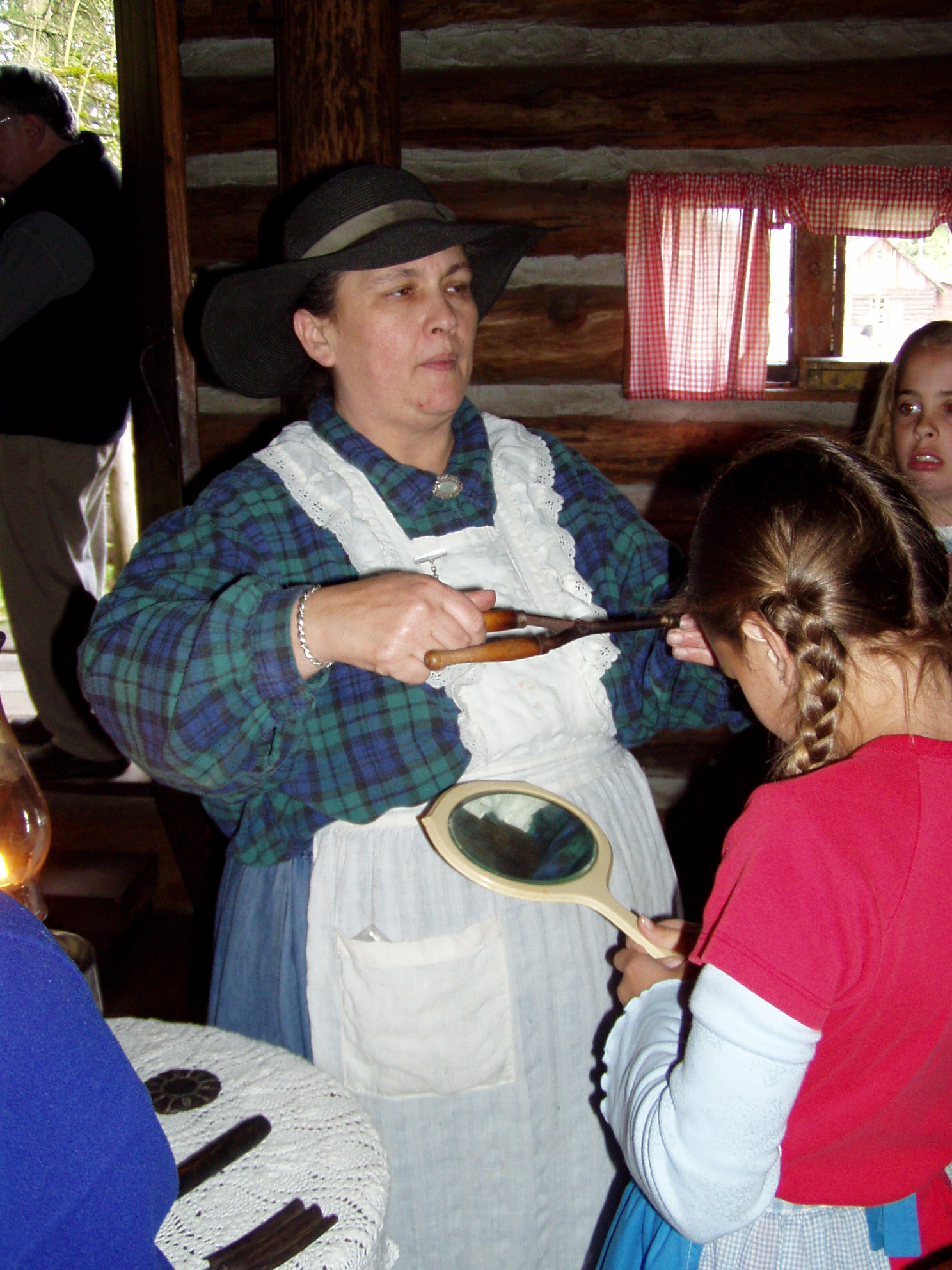 students at pioneer cabin learning about curling iron that you heat in a fire